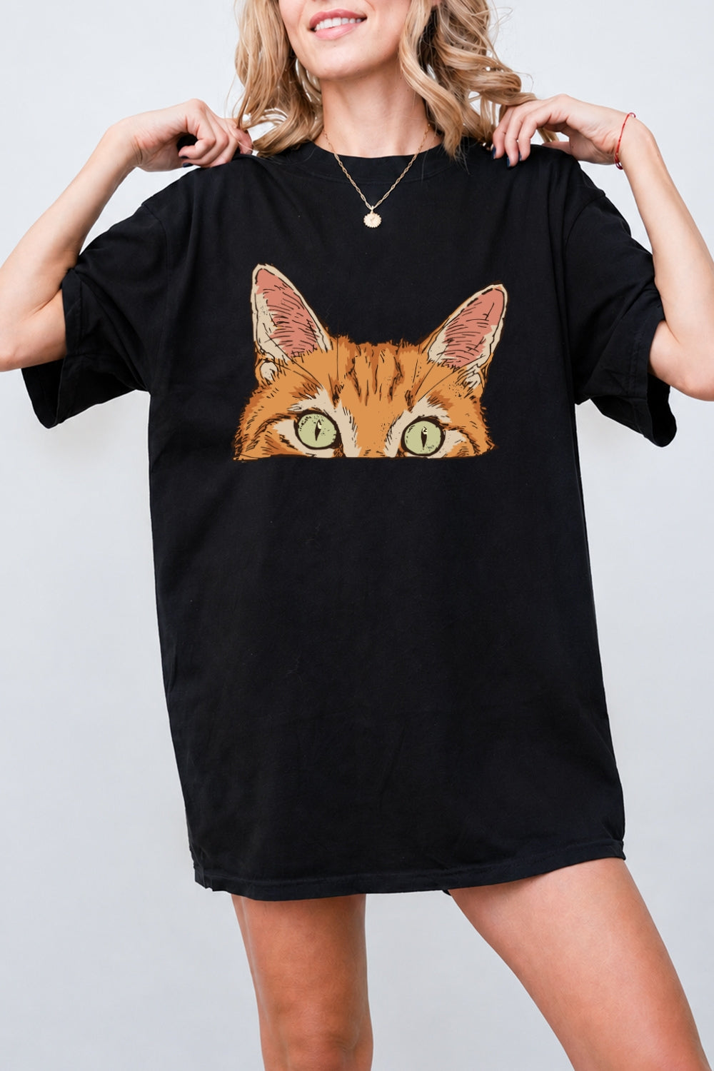 Curious orange tabby cat peeking tee