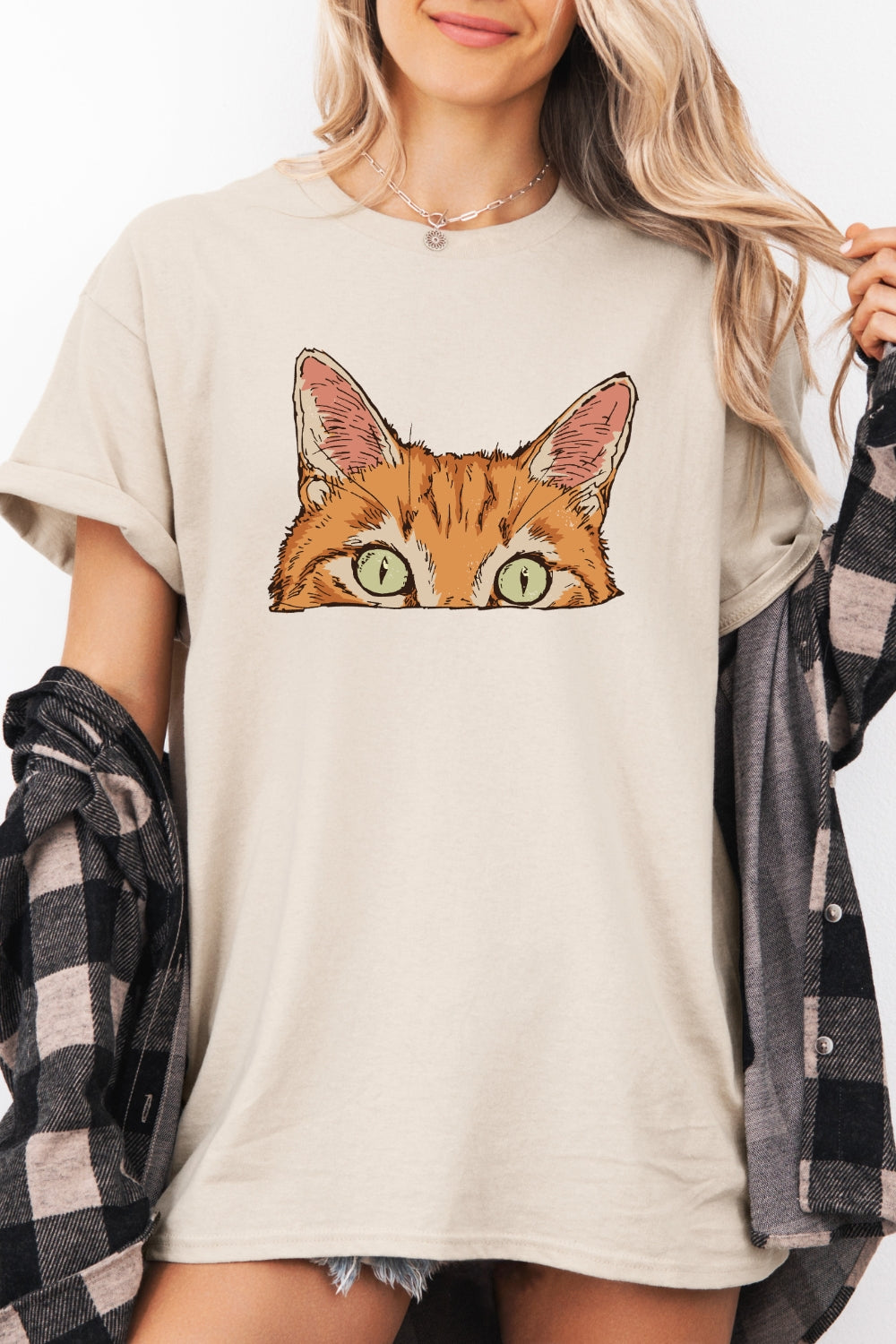 Curious orange tabby cat peeking tee