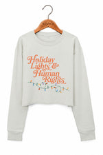 Holiday lights and human rights crop sweatshirt