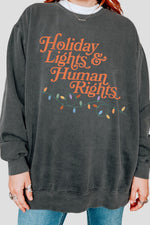 Holiday lights and human rights sweatshirt