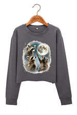 Raccoons gather around the moon crop sweatshirt