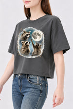 Raccoons gather around the moon crop top