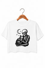 Skeleton holding a cat crop top