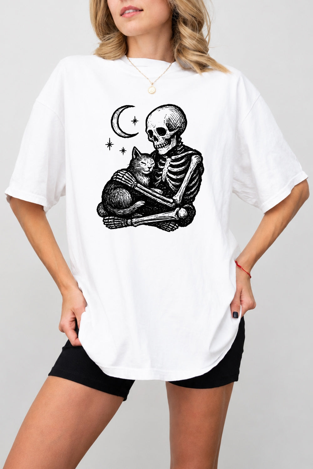 Skeleton holding a cat tee