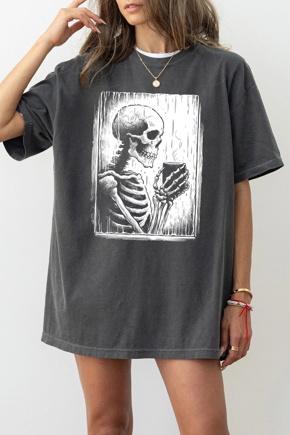 Skeleton holding a hot drink tee